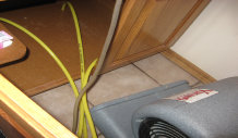 Image Of Air Mover Drying Under Cabinets