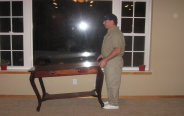 Image Of Technician Moving Furniture For Steam Cleaning